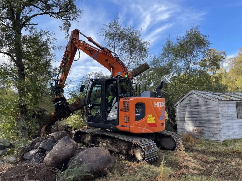 An excavator felling trees at River Muick